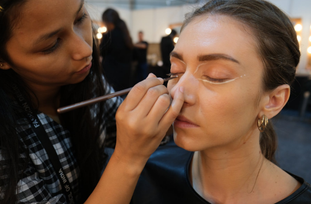 woman applying makeup
